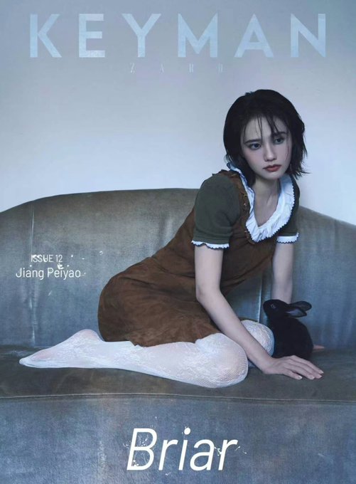 A magazine cover for KEYMAN ZARD Issue 12 features Jiang Peiyao (姜珮瑶) sitting on a gray couch with a black rabbit, wearing a brown dress over an olive top and white tights, with the headline "Briar" displayed at the bottom, showcasing her stylish short haircut highlighted in the accompanying caption.
