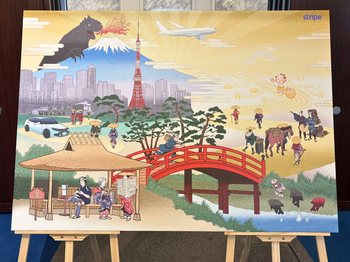 StripeJapan's tweet photo. 本日、Stripe Tour Tokyo 2026 開催！

会場の展示エリアの入り口付近に、Stripe 日本展開 10 周年を記念した特別な浮世絵アートを展示しています。

ぜひ一緒に写真を撮って #StripeTourTokyo をつけて投稿してください！

🎨 作品について
江戸時代に栄えた木版画芸術「浮世絵」の構図・線描・色彩にインスピレーションを得た本作のタイトルは、「Stripe、日本とともに 10 年…そしてこれから」。
作品の左手には、Stripe が日本企業の皆さんとともに歩んだ 10 年の歴史が描かれています。中央に架かる橋は、今まさに急速に到来しつつある AI 時代への過渡期を象徴。そして橋の先には、テクノロジーと経済が新たな地平へと向かう、これからの 10 年の景色が広がっています。

🔎 隠れモチーフを探してみてください
富士山、東京の街並み、伝統的な街道、水辺など日本の原風景の中に、Stripe がともに歩んできたマンガや映画などのコンテンツ、ゲーム、航空、メディア、自動車、AI など、日本のビジネス・産業を象徴するモチーフがたくさん隠れています。あなたの業界は見つかりますか？