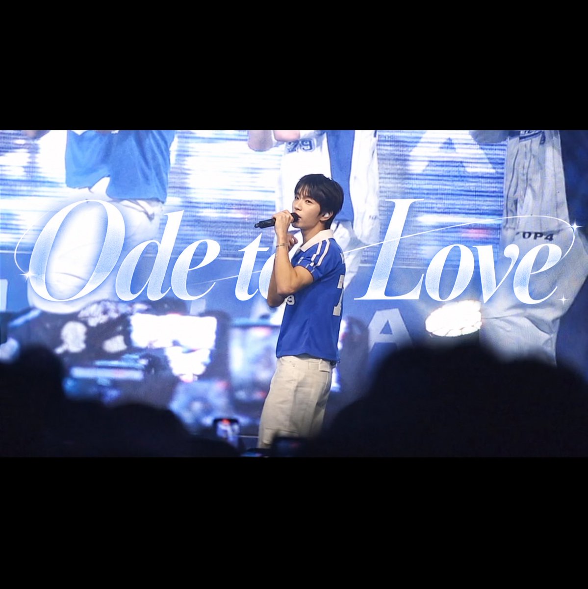 A concert performance photo shows a male performer in a blue jersey singing into a microphone, with 'Ode to Love' displayed in elegant script across the background screen.