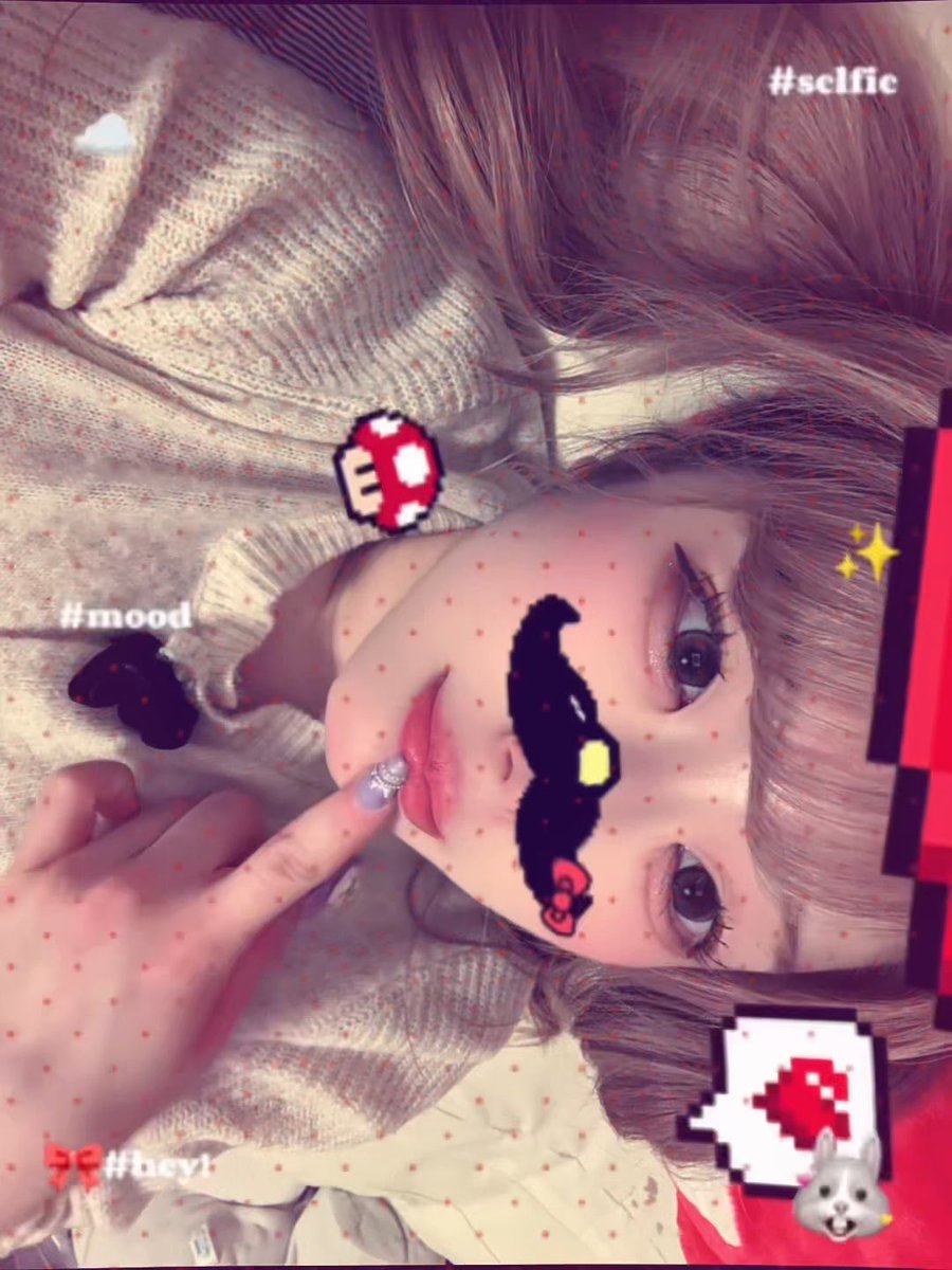 A selfie of a person with light hair wearing pixelated sunglasses filters, featuring Snapchat overlay text including '#selfic', '#mood', and '#hey1'.
