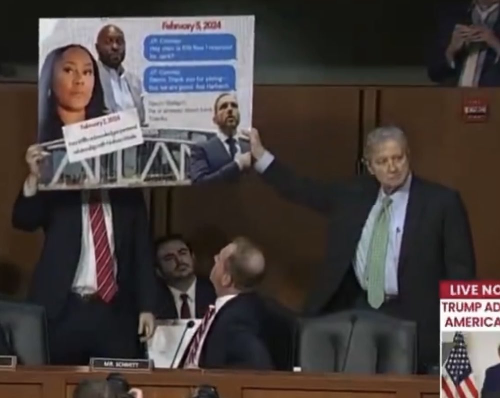 MEPFuller's tweet photo. I don’t think we’re adequately appreciating that Sen. John Kennedy was so eager to get in on Eric Schmitt’s gotcha moment that he helped hold up the posterboard. 

He even stares down Klobuchar with that look of “check and mate!” https://t.co/HiAnWV8yRe