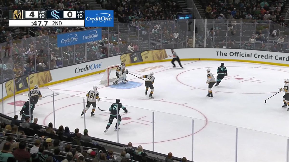 A Vegas Golden Knights hockey player breaks away toward the Seattle Kraken net during the 2nd period with the Golden Knights leading 4-0 on the scoreboard. The Caption "Jack Eichel on the breakaway!" corresponds to the player in the white jersey carrying the puck past defenders into the offensive zone.