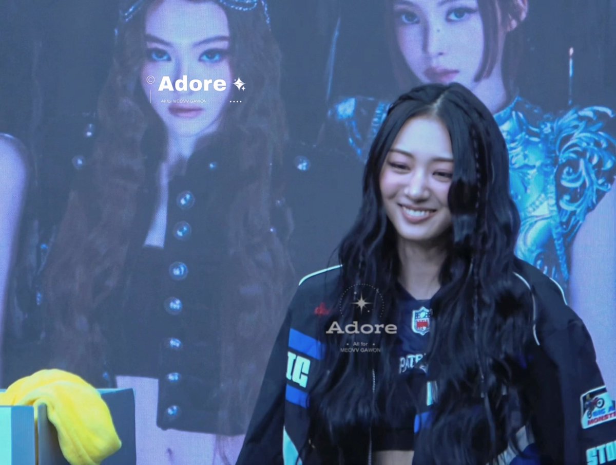 Concert/promotional image featuring a smiling woman with long black hair in front of a backdrop displaying the same person, with 'Adore' branding and 'All for MELSKI GAWON' text.