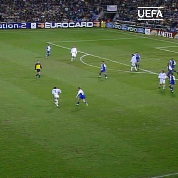 A UEFA Champions League match in progress on a green pitch, with players in white and blue kits competing near the goal area, while advertising boards displaying "EUROCARD," "FORD," and "AMSTEL" line the stadium perimeter. The UEFA-branded broadcast footage ties into the post celebrating Santiago Solari's goals in the #UCL.