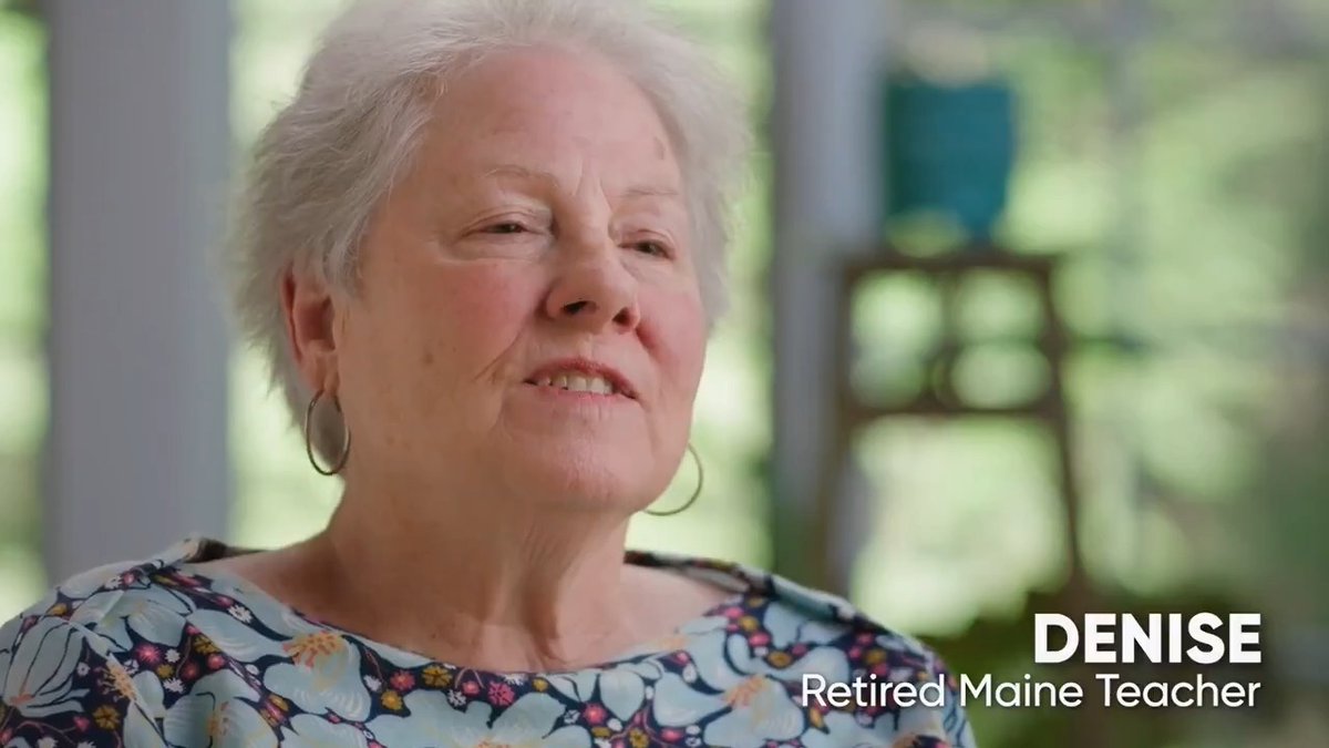 A close-up of an older woman with short gray hair wearing hoop earrings and a floral top; on-screen text reads 'DENISE - Retired Maine Teacher'.