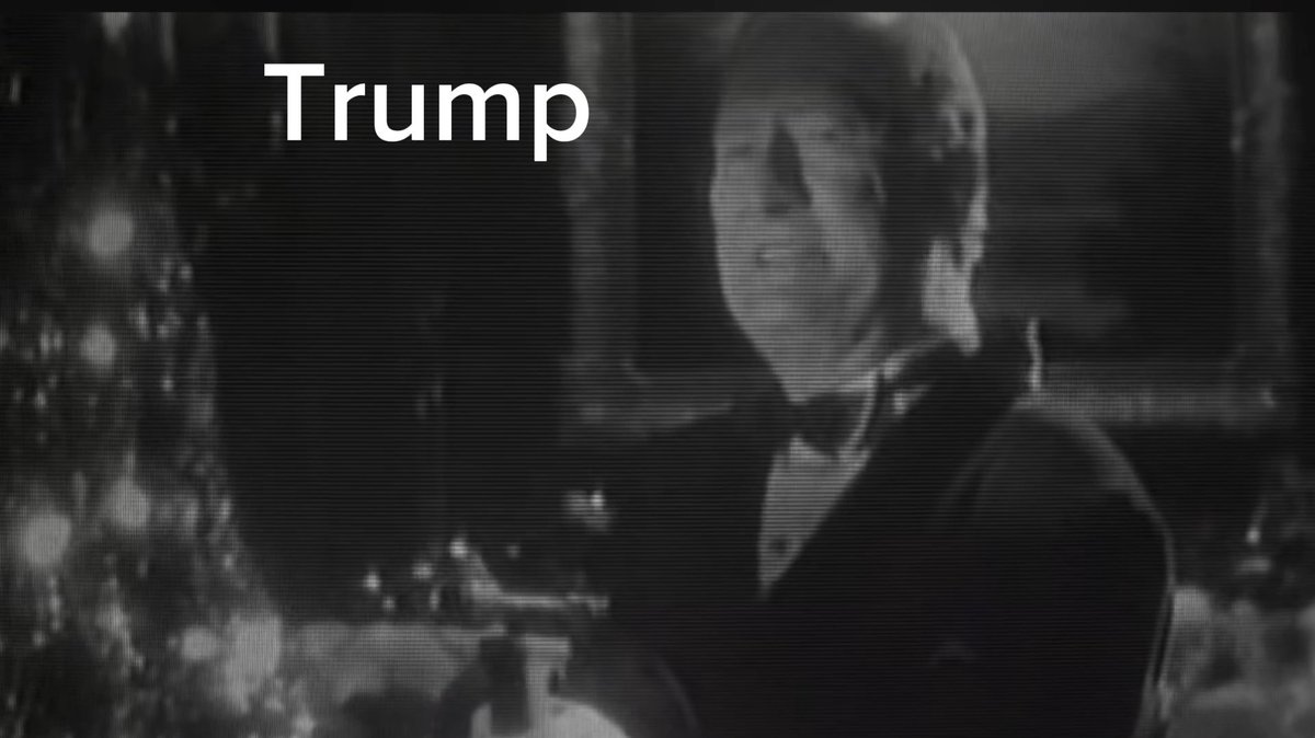 Black and white image of a person wearing a skull mask with the text 'Trump' overlaid in the upper left corner.