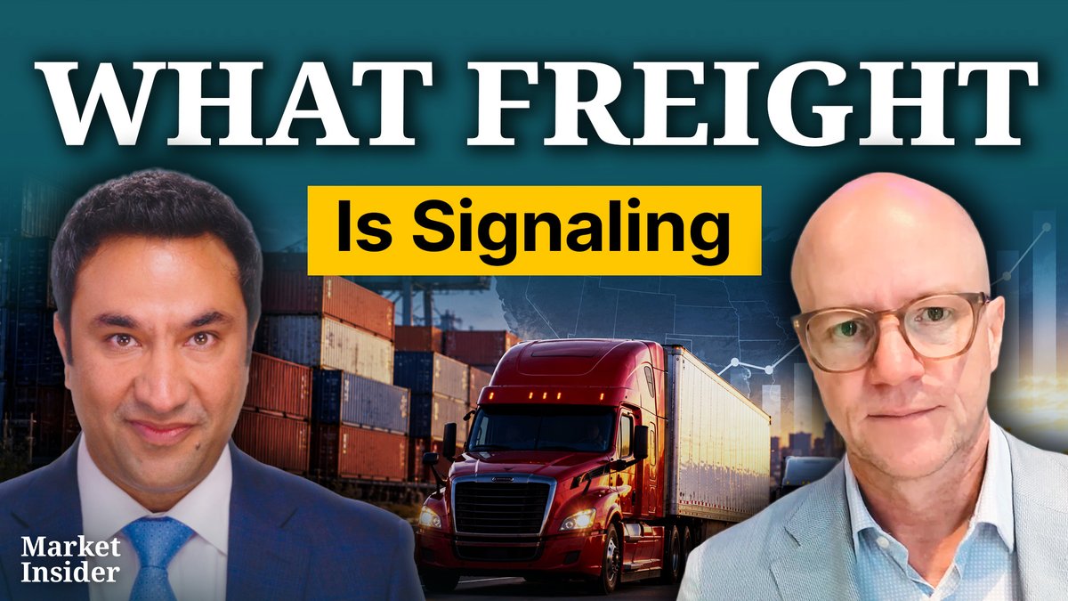 A Market Insider video thumbnail titled "WHAT FREIGHT Is Signaling" featuring two commentators on either side of a red semi-truck.