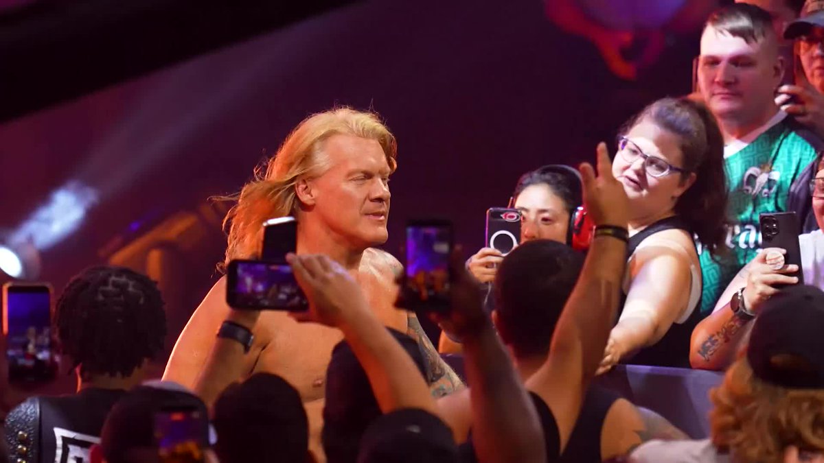 Wrestler Chris Jericho interacts with fans holding up phones to record him at the AEW Collision: Grand Slam France event, as referenced in the post about his match with Nick Wayne airing on TBS and HBO Max.