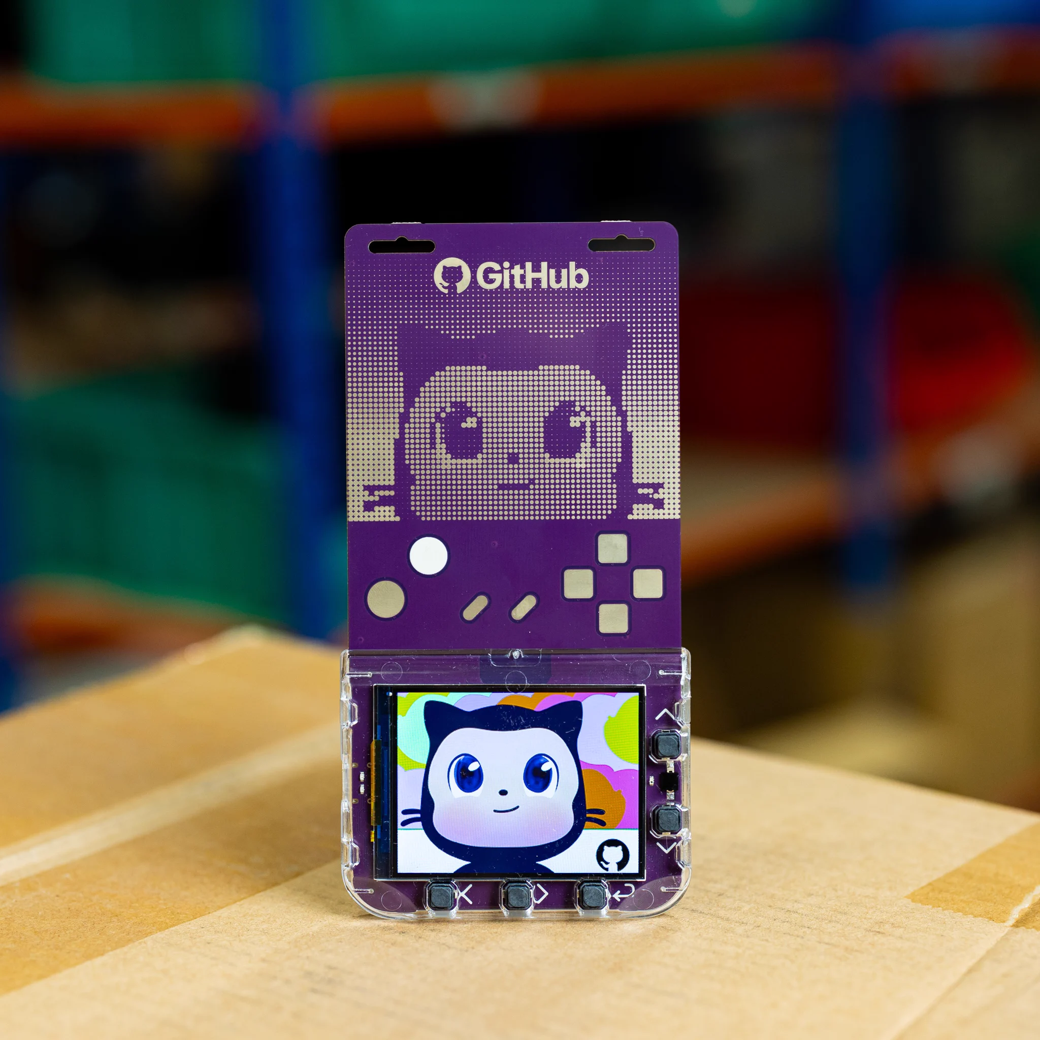 GitHub Universe 2026 programmable badge. It is purple, has gaming controller motifs, and an image of Mona. 