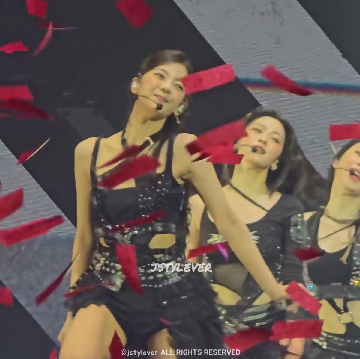 A performer in a black sparkly outfit dances on stage amid falling red confetti, with the watermark 'JSTYLEVER ALL RIGHTS RESERVED' visible.