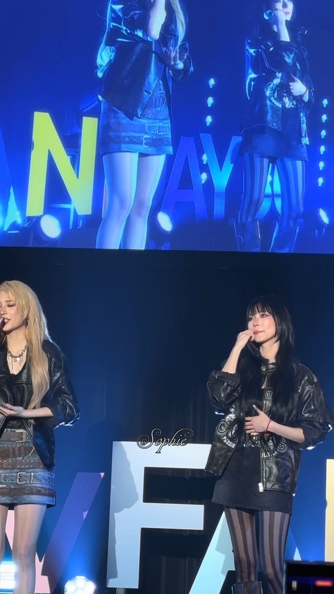 Two performers in black leather jackets perform on stage at the "JANJINGJING FANDAY 36" event in Tokyo, with the "JANYAY" lettering visible in the background and one performer emotionally covering her mouth, reflecting the caption's description of emotional crying moments during the fan event.