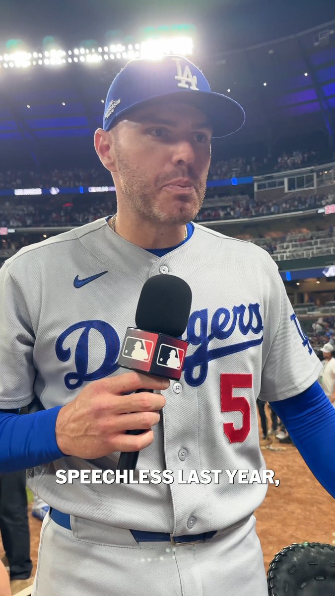 A Los Angeles Dodgers player wearing jersey #5 holds an MLB-branded microphone during a postgame interview at the stadium, with on-screen text reading "SPEECHLESS LAST YEAR," suggesting this is Freddie Freeman reflecting on the previous year's playoff exit after an NLDS Game 3 victory.