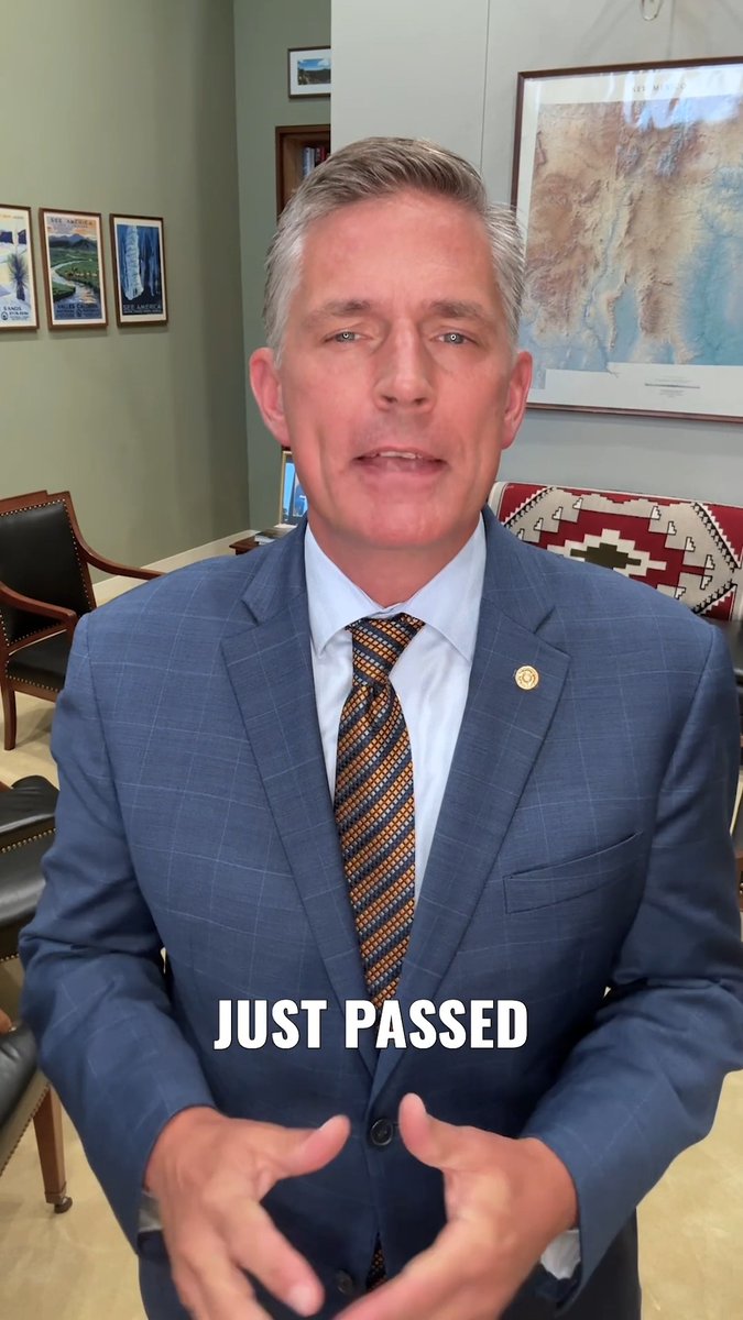 A man in a blue suit and patterned tie speaks to the camera in an office setting with the text 'JUST PASSED' overlaid.