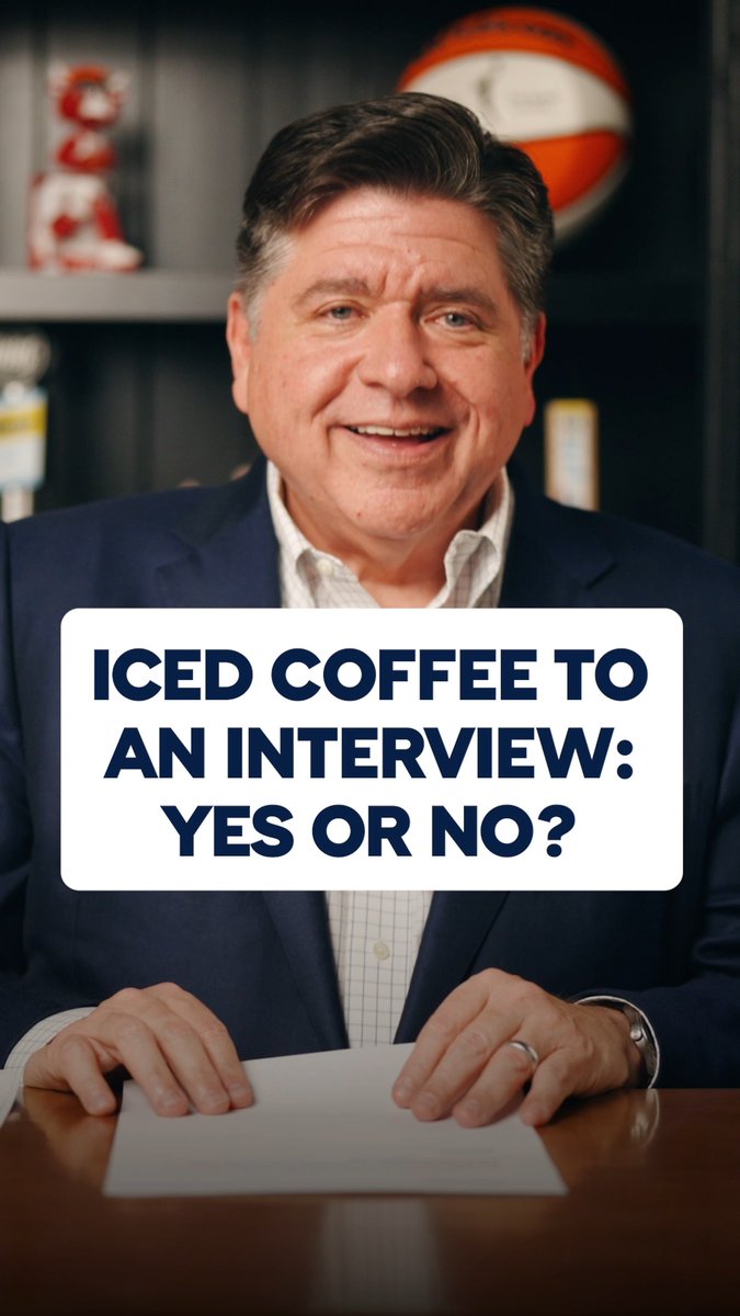 A man in a navy blazer sits at a desk holding a paper, with text overlay reading 'ICED COFFEE TO AN INTERVIEW: YES OR NO?'