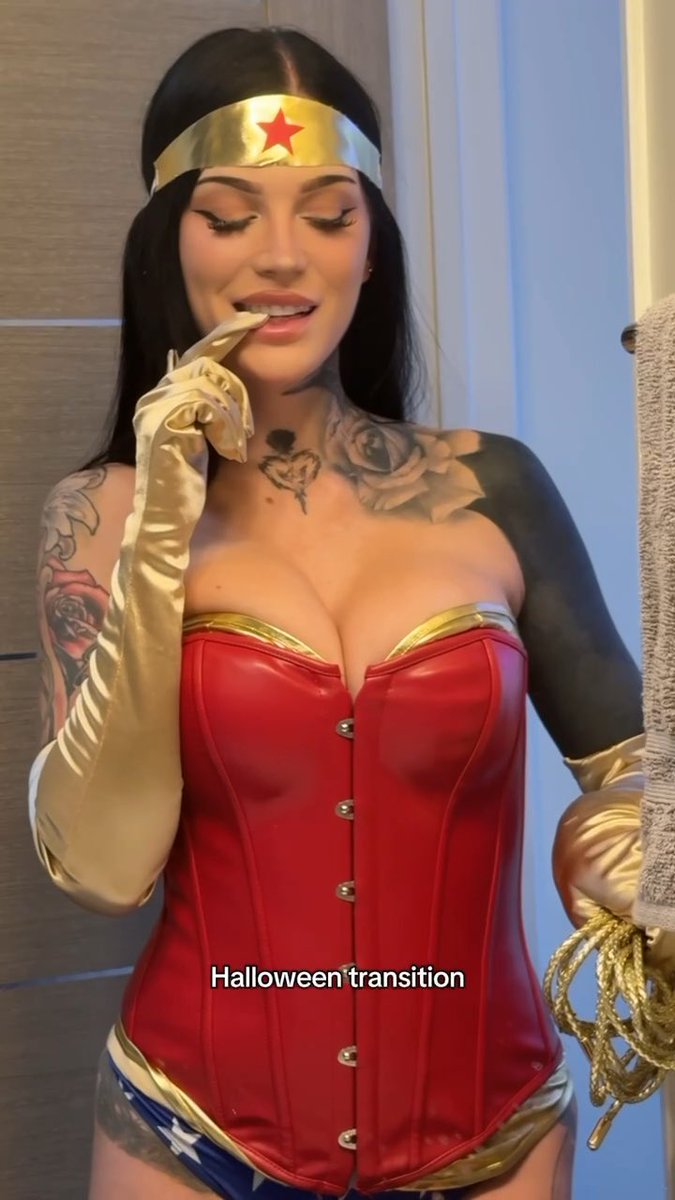 A woman poses in a red corset, gold tiara with a red star, and long gold gloves, appearing to be in a Wonder Woman costume. The caption "Halloween transition" is overlaid on the image, suggesting a costume reveal for the holiday.