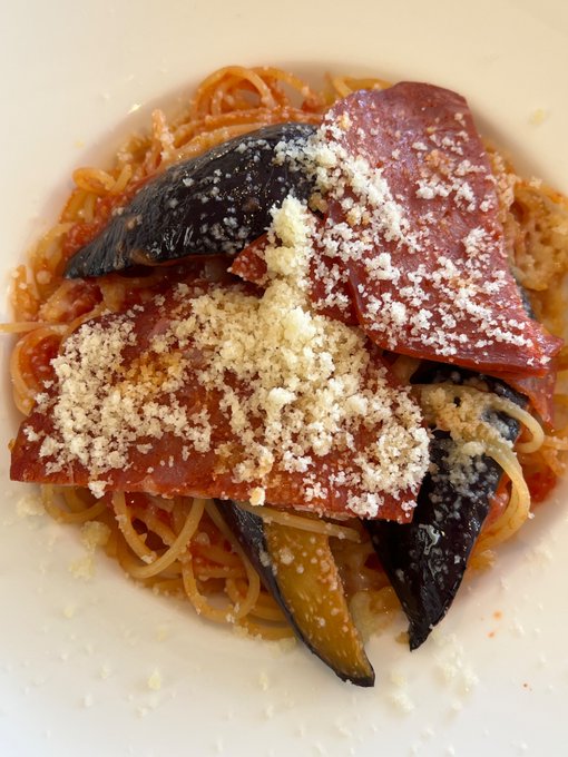 A plate of spaghetti topped with tomato sauce, grilled eggplant, cured meat (likely bacon or speck), and a generous dusting of grated Parmesan cheese. The dish appears elegantly plated at a restaurant called 碧テラス (Ao Terrace), with the hashtag #キリトリセカイ ("Kiritori Sekai") suggesting this is part of a curated photo series capturing the photographer's personal world through food imagery.
