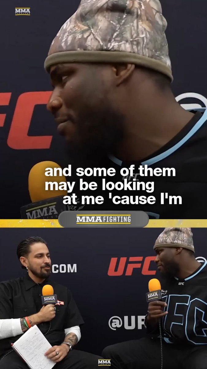 UFC heavyweight Anthony "The V" Wint speaks into an MMA Fighting microphone during a post-fight press interview, with the caption showing him sizing up the rest of the division.