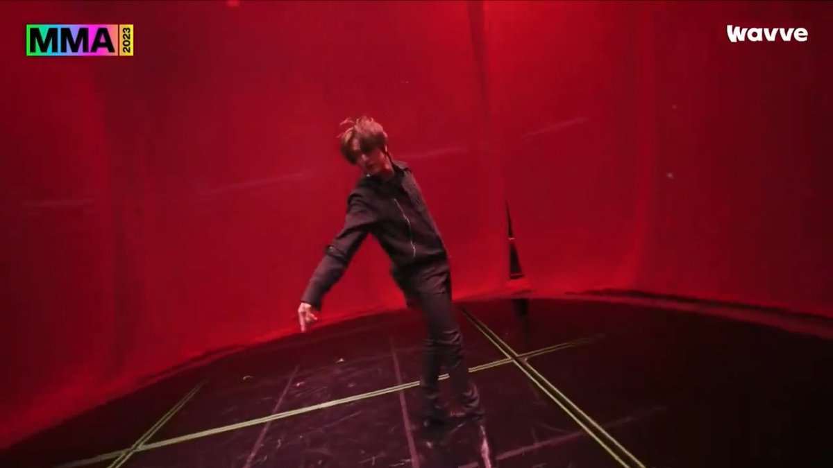 Haechan of NCT performs a dramatic solo dance break intro to "Poison" at the MMA 2023 ceremony, shown on the Wavve broadcast.