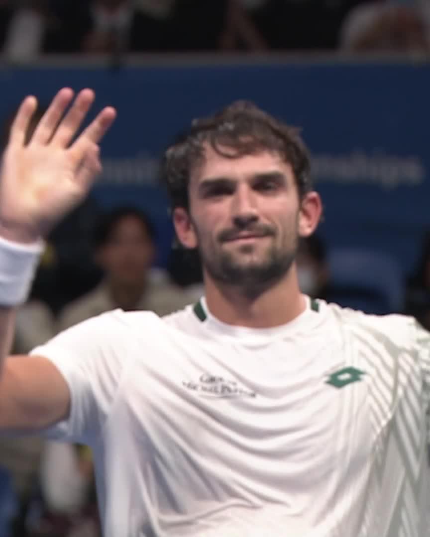 Valentin Vacherot waves to the crowd after his 7-6, 7-6 victory over Alexander Blockx at the Japan Open Tennis tournament, celebrating his first-round win.