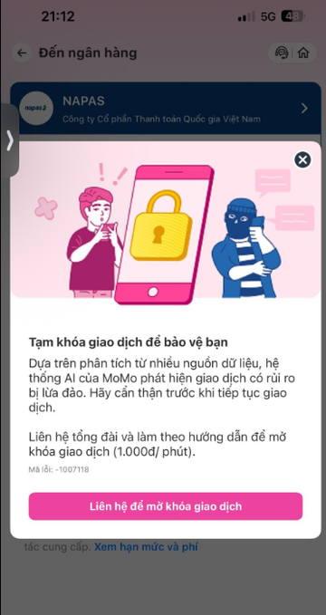 A Vietnamese mobile banking screen from 'NAPAS' showing a fraud warning to lock transactions, featuring an illustration of a thief and a phone with a lock icon.