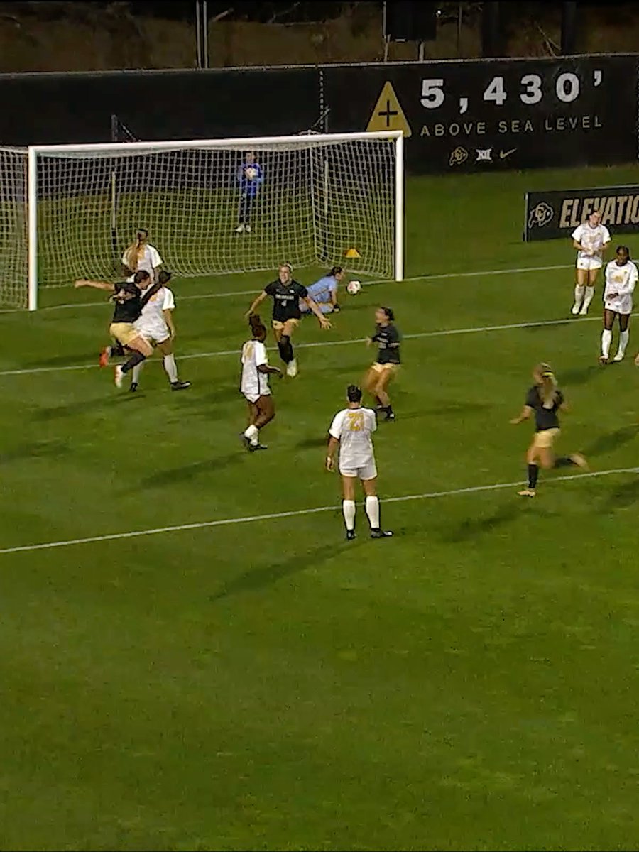 A women's soccer match being played at night with a sign reading '5,430' ABOVE SEA LEVEL' and 'ELEVATION' visible in the background.