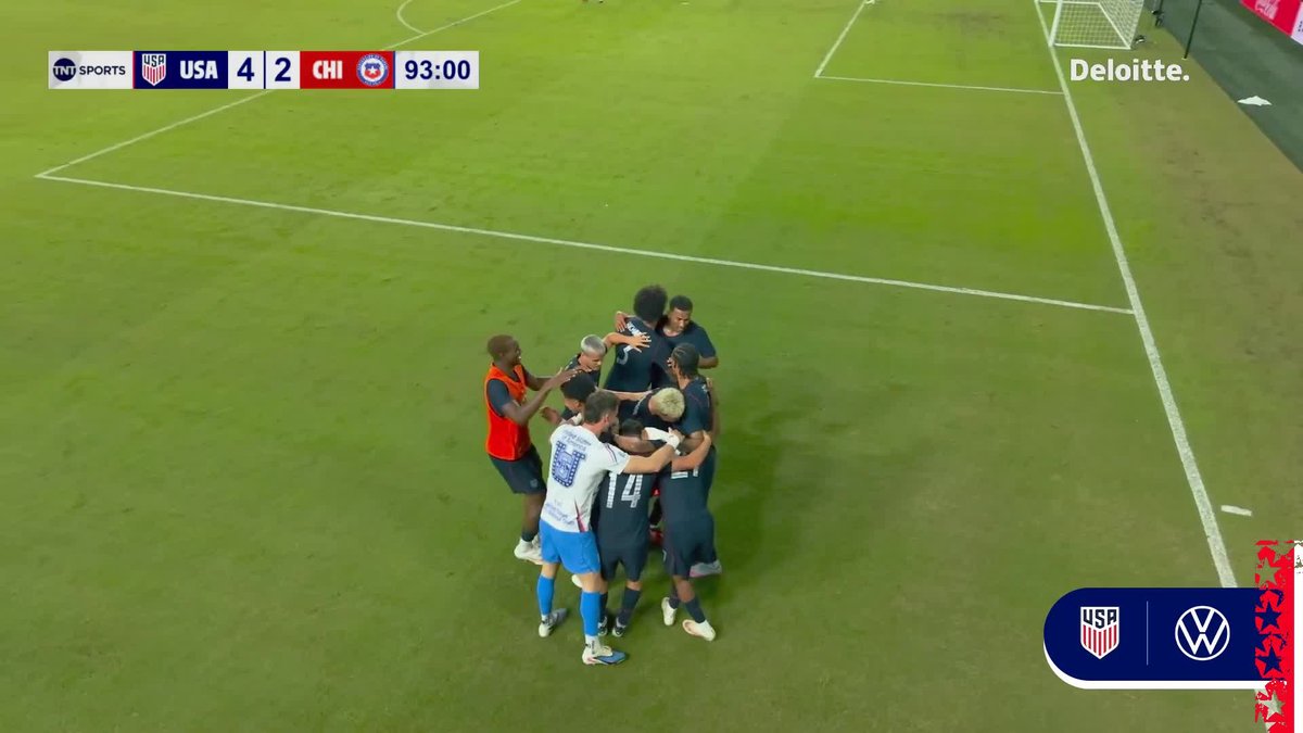 USA soccer team celebrates on the field after a 4-2 victory over Chile, with the scoreboard showing 93:00 remaining in the match.