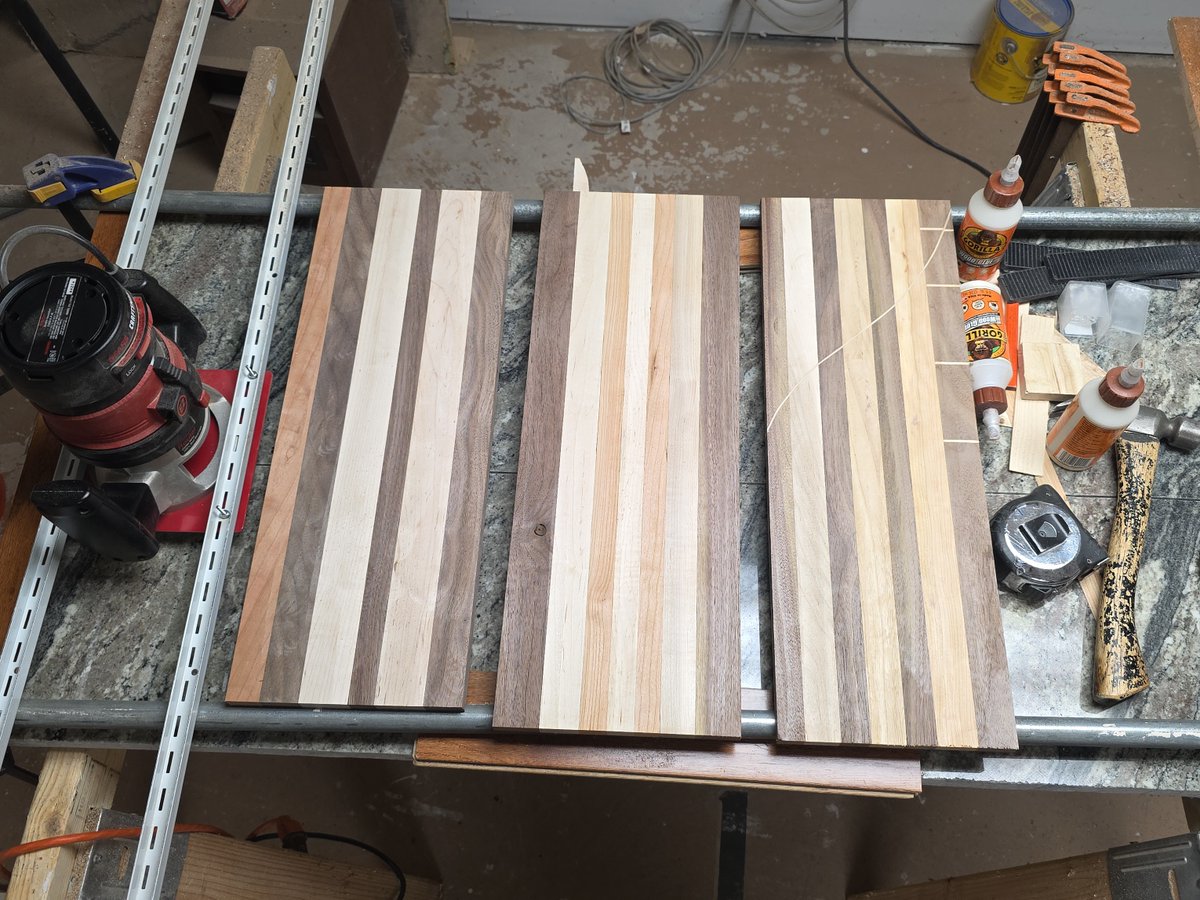 GDWorkbench's tweet photo. Three striped cutting-board panels on the bench during layout and glue-up prep. Project GD-P-446: https://t.co/e38t15O8mf #GDWorkbench #WorkInProgress https://t.co/CcGXlkCk1x