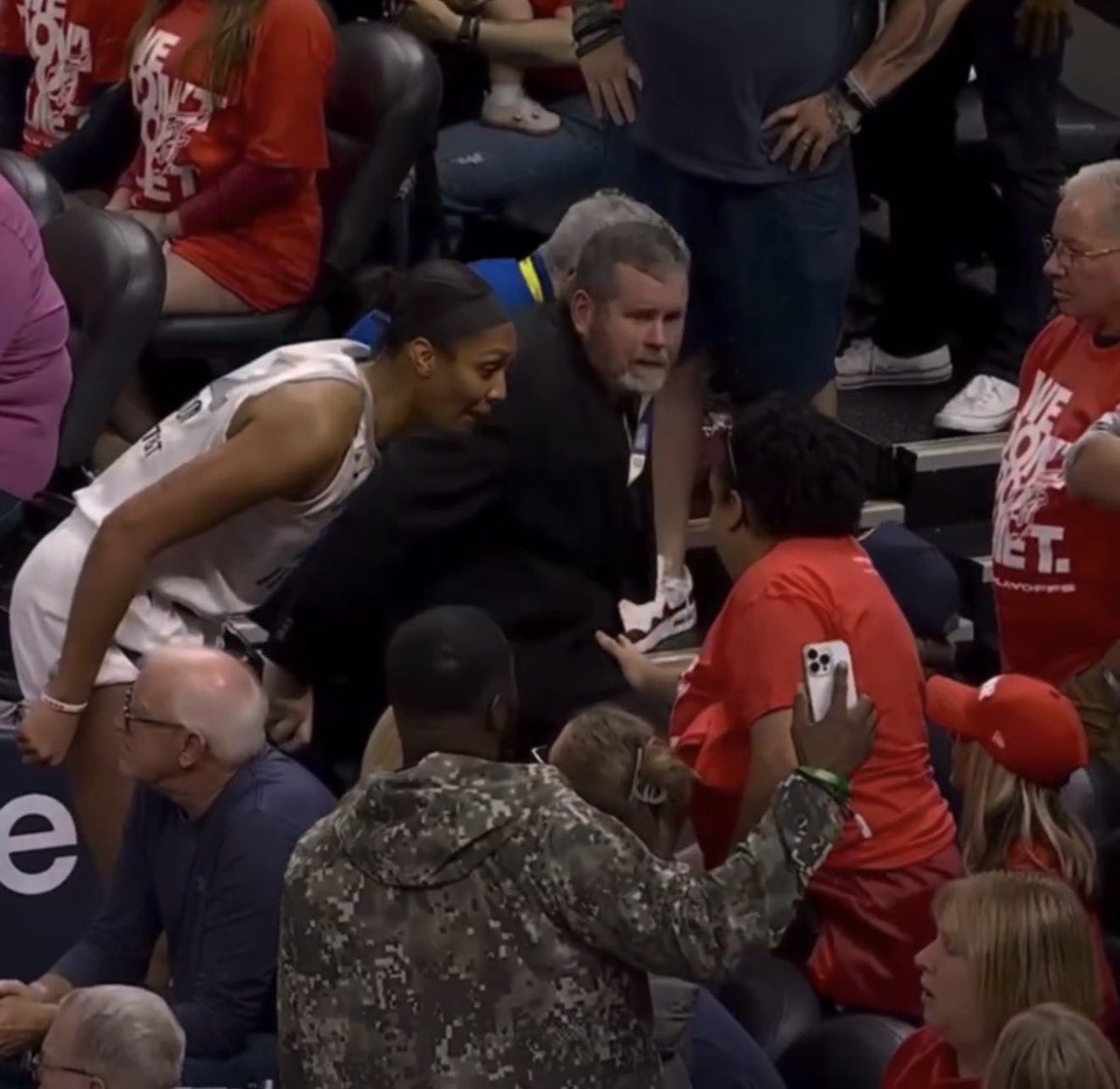 JonnyRoot_'s tweet photo. Why was Las Vegas Aces A’ja Wilson not ejected for entering the stands in Game 2 vs Fever?

According to Rule 12A, Section V:
Any player, coach, or trainer who deliberately enters the spectator stands during a game will be automatically ejected. [1] The rulebook breaks down the exact protocol and boundaries for this infraction as follows:

Automatic Ejection and Review: The offender is disqualified immediately from the game, and the officiating crew must report the incident via email directly to the WNBA Commissioner for further review. This review frequently triggers subsequent league discipline, including heavy financial finesand potential multi-game suspensions based on the severity of the confrontation.
Defining the Stands: The rule book explicitly states that the first row of seats is considered the beginning of the spectator stands.