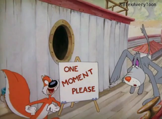 A still from a Tex Avery cartoon showing a fox holding a 'ONE MOMENT PLEASE' sign next to a grey dog character leaning against a wooden ship structure.