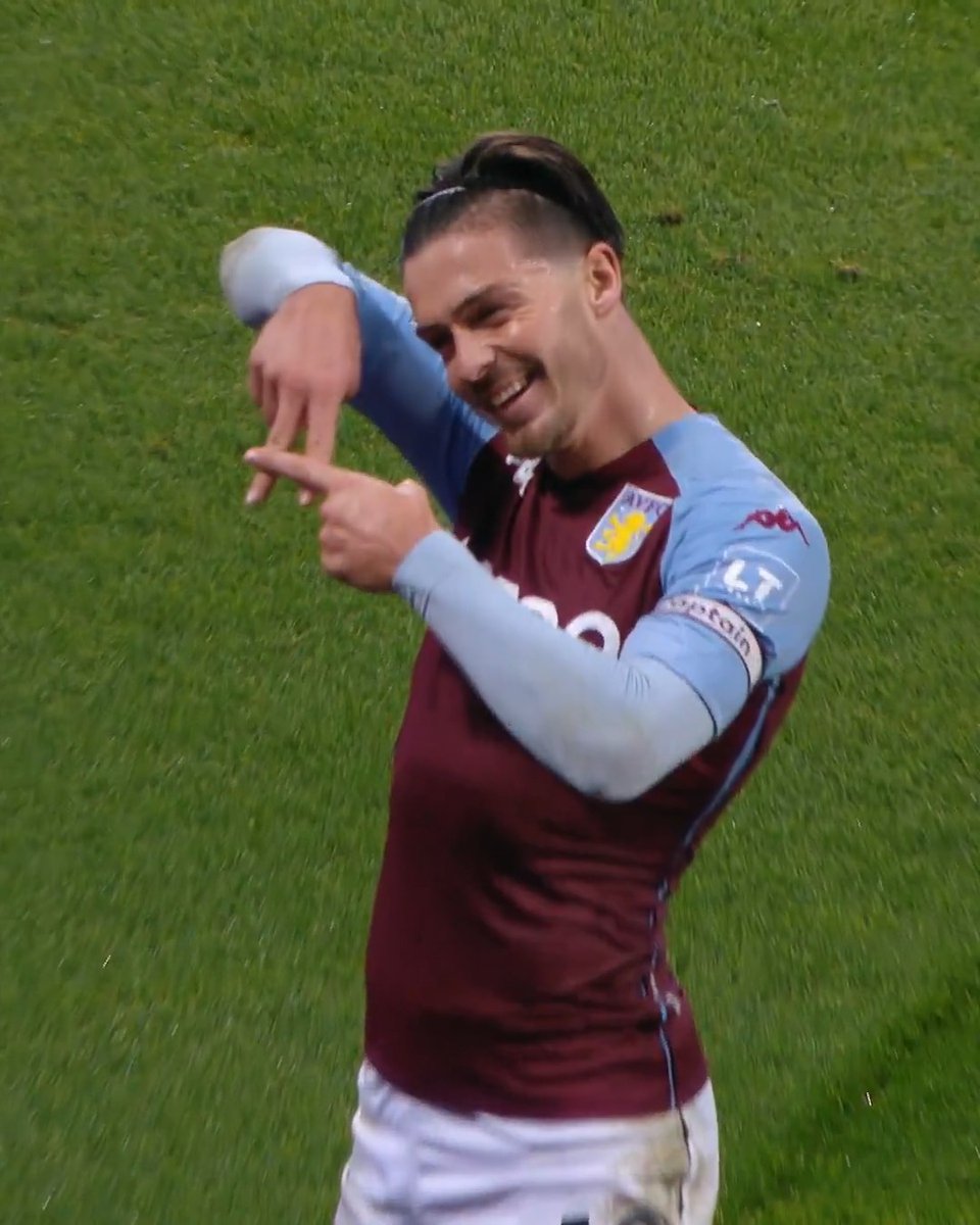 Aston Villa player Jack Grealish, wearing the #10 jersey, performs a "dabbing" celebration on the pitch. The claret and blue kit, visible sponsor "LT," and captain's armband tie directly into the post referencing Villa's emphatic 7-2 victory over Liverpool.