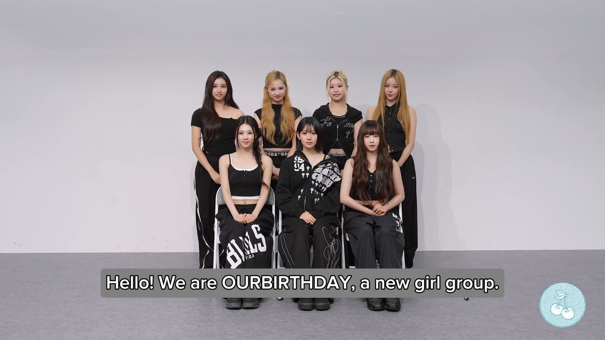 A group of seven young women pose against a white background with the caption 'Hello! We are OURBIRTHDAY, a new girl group.'