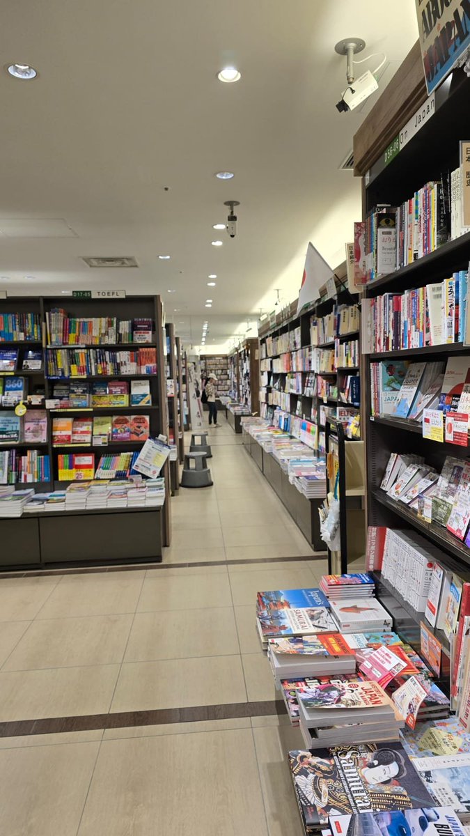 MisraSundeep's tweet photo. Sanseido Books at Nagoya station was a necessary stop. Inside, the outside noise, which isn't always to my liking, instantly diffuses. Sanseido holds roughly 80,000 books, mostly in Japanese, though they do have an English section with both fiction and non-fiction.
​The woman arranging books in the English section pointed me toward Seicho Matsumoto when I asked for her pick of Japanese crime writers. Without mentioning the usual names—Keigo Higashino, Soji Shimada, or Edogawa Ranpo—she pulled a slim volume from a stack, handed it to me, and said softly, "Read this." It was Matsumoto’s Tokyo Express.
​As I browsed the back cover, she returned, silently handing me Three Assassins by Kotaro Isaka. I was grateful and thanked her. She bowed slightly, replying with a quiet "Thank you."
​Sanseido is a massive store—an entire floor dedicated to books, manga, comics, magazines, stationery, and a café. Multitudes of lives live and breathe inside bookstores. Millions of words tell hundreds of stories. It’s an insulated world, embracing anyone who steps into its fold.