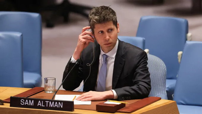 Sam Altman sits at a UN Security Council desk with his nameplate visible, wearing a dark suit and blue tie while listening through an earpiece.