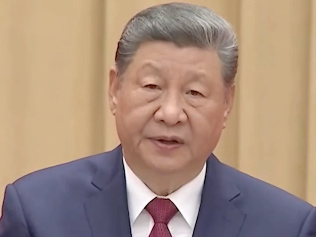 President Xi Jinping, dressed in a suit and tie, delivers an important speech, aligning with the accompanying post about China's economic growth and improving people's wellbeing.
