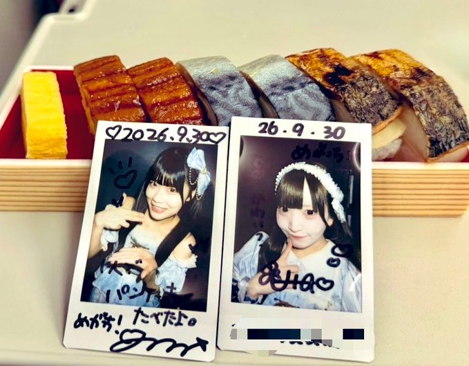 Two signed Polaroid photos dated '20 26.9.30' of two young women in cosplay, placed in front of an assortment of Japanese sweets.