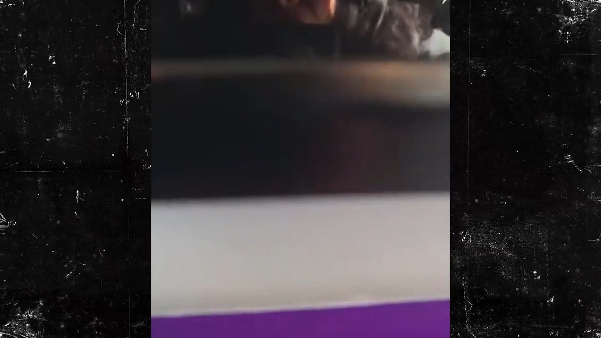 A dimly lit, blurry view from inside an aircraft cabin shows what appears to be a chaotic scene with passengers gathered in the aisle, consistent with reports of an Israel-bound flight that was diverted to Saudi Arabia following a possible terror attack.