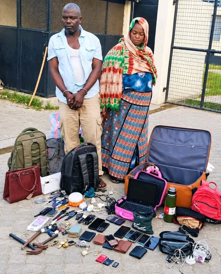 ivymuthe's tweet photo. This couple has been operating in Mombasa. They are from Tanzania and have been targeting passengers on Mombasa-to-Nairobi buses who appear to have a lot of luggage and cash.
The woman sits next to the victim, sprays a knockout substance, and the pair then steals everything before getting off the bus unnoticed. The victim remains unconscious. On the 18th they did this to an elderly man and took all his belongings. He later found himself at Tudor Hospital with nothing.
After investigations, DCI arrested 52-year-old Paskale Frugenze and his 47-year-old wife, Redemta Revelian. They were found with laptops, an iPhone 17 Pro Max, other mobile phones, and various other items.
If you have been robbed by this couple on those Mombasa buses, report to Makupa Police Station.