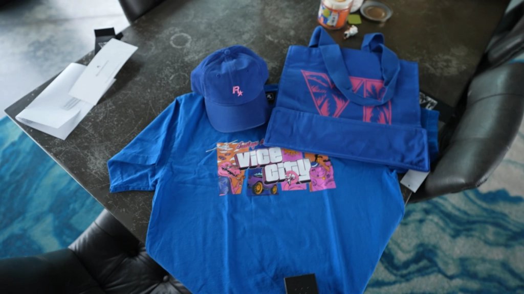 iGrandTheftAuto's tweet photo. Last week we published a list of the upcoming GTA 6 merch we found on the Rockstar Store. Turns out the packages sent to creators include some of the items from that list:

Parody Shards Tee - Blue
Rockstar Flexfit Custom Blue/Pink 
GTA VI Tote Bag - Blue
GTA VI Zippo 
GTA VI Hologram Sticker Pack 

Would you buy these?