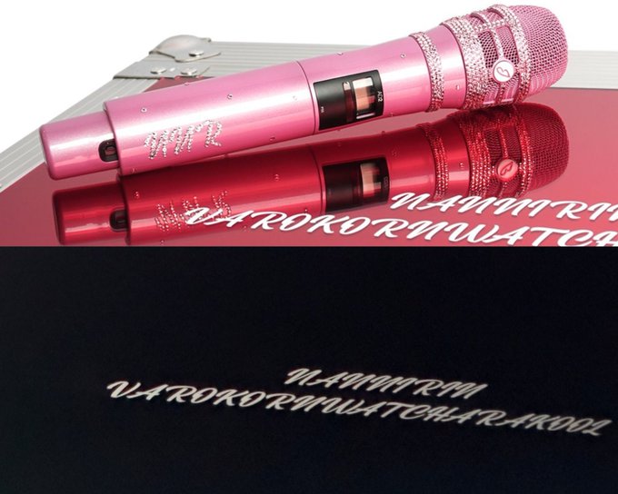 Two rhinestone-studded wireless microphones, one pink and one red, displayed on a reflective surface with text reading "U4ROKORMW4TORRRAKRRR".