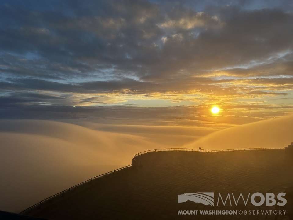 MWObs's tweet photo. Summit staff have been treated with views of a nearly full undercast layer of clouds through breaks in the fog over the past 24 hours, pictured here shortly after sunrise yesterday morning (9/29). https://t.co/htweatDFTz