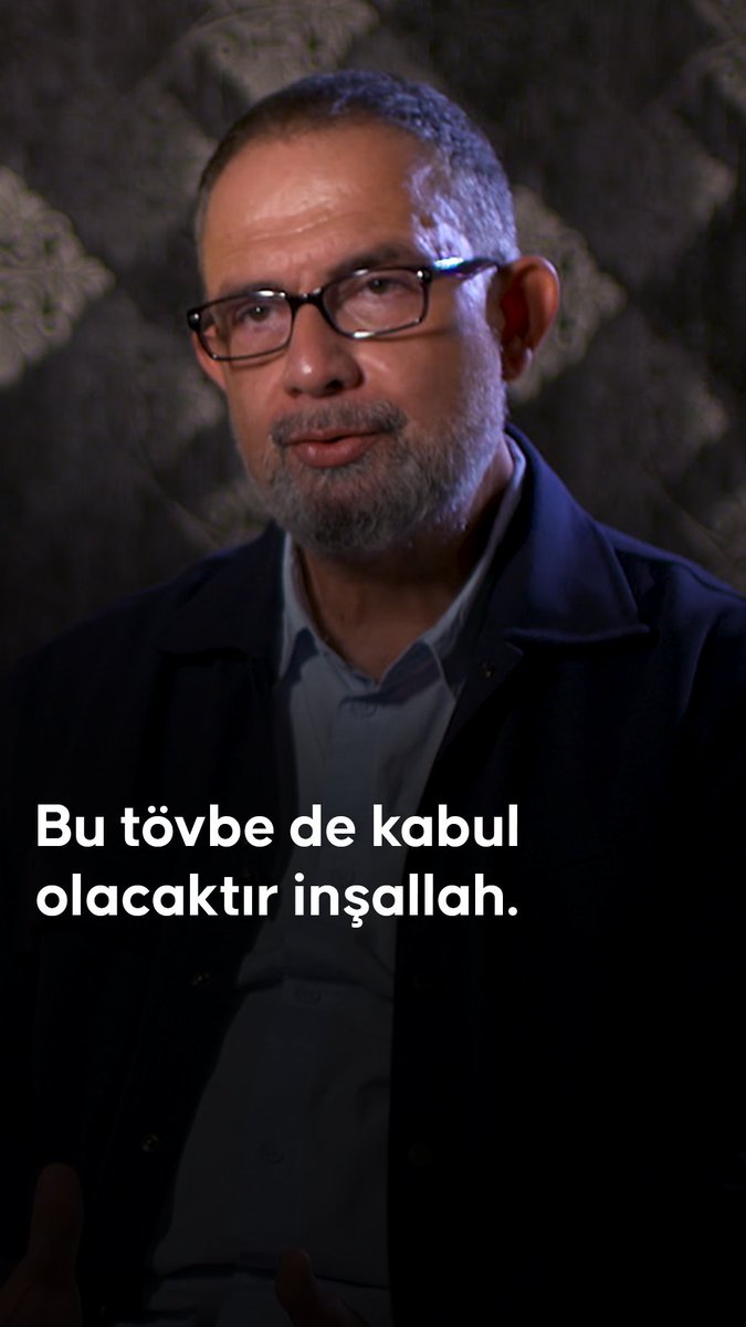A man with glasses and a gray beard in a dark jacket, shown in a video interview setting with Turkish text overlay reading 'Bu tövbe de kabul olacaktır inşallah.'