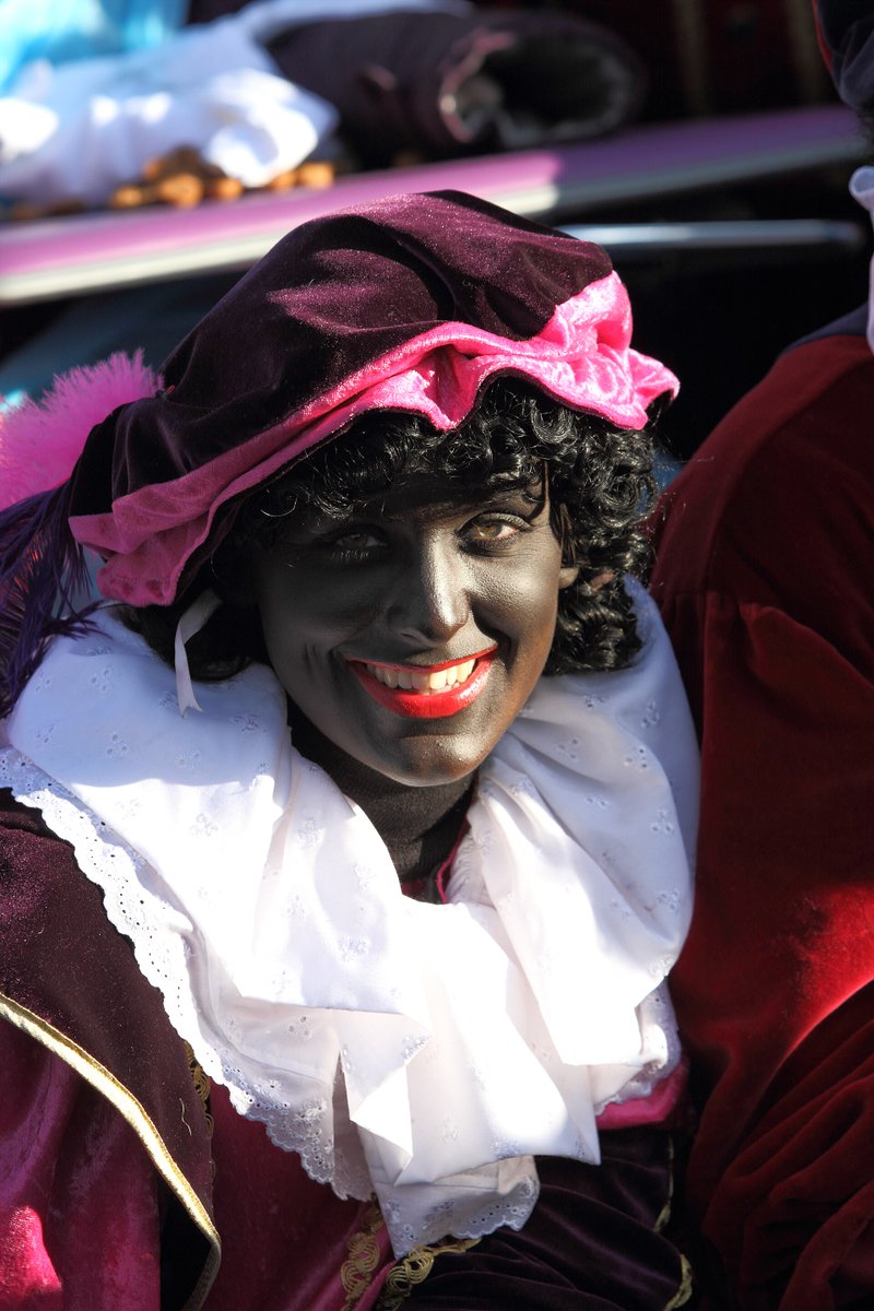 El_Sycophanto's tweet photo. @BigWave372 In the Netherlands we have a fun tradition called Sinterklaas (the origin of Santa Claus). But ours doesn't have elves - he has Zwarte Piet ("Black Pete") as a helper.  Pic related. Zwarte Piet traditionally also wears a bonnet 😅 https://t.co/U17BmLZ6tW