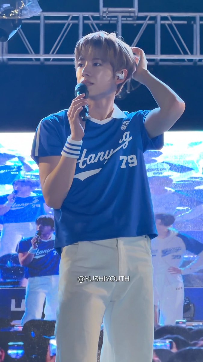 YUSHI performs at Hanyang University ERICA Festival wearing a blue jersey with "79" and partial text reading "tany," matching the referenced "Yutnyangi Grooming" theme.