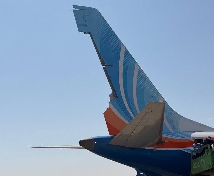 TripppleSeven7's tweet photo. FLY DUBAI TORN RUDDER:
Look at these two photos. The first shows what the 737 MAX’s rudder should look like. The second shows the damaged rudder after today’s flydubai incident. The rudder is basically the aircraft’s “steering” surface in the air. When the pilots move it, it helps turn the aircraft’s nose left or right and keep it pointed where they want to go.

Now imagine trying to land with part of that surface torn away. The pilots had to deal with an aircraft that was no longer responding exactly as it normally would.