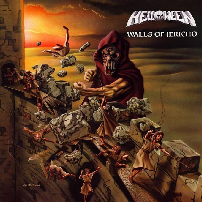 The album cover for Helloween's 'Walls of Jericho,' featuring a hooded skeletal figure destroying stone walls while people flee in panic, with artwork credited to Uwe Karczewski.