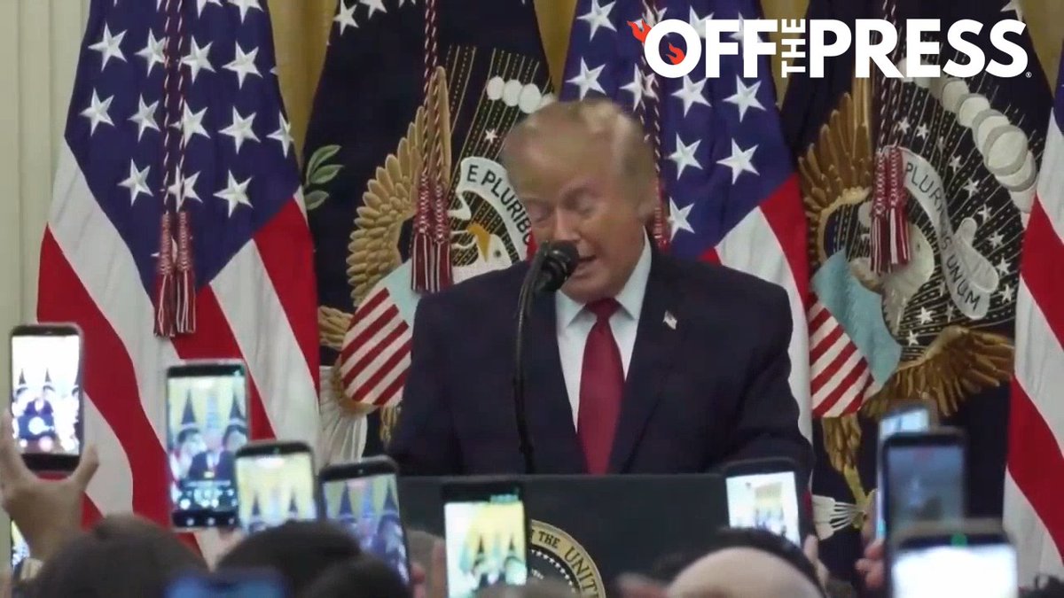 Former President Donald Trump speaking at a podium with American flags in the background, while an audience records him on their smartphones; an 'OFF THE PRESS' watermark appears in the corner.