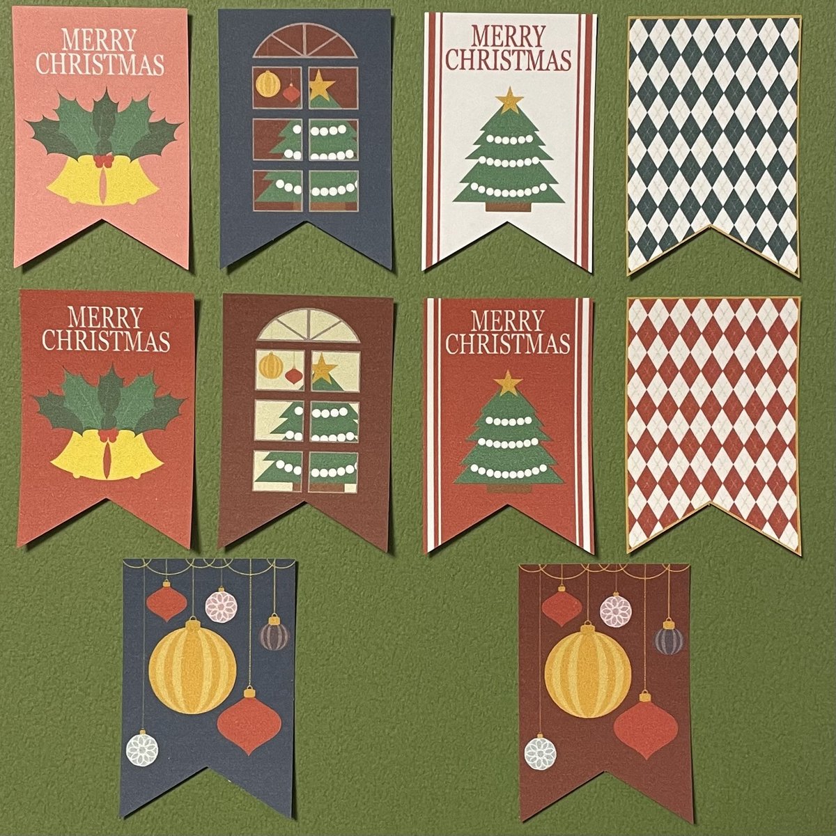 SUNDAY_E_INFO's tweet photo. 販売中【クリスマス旗シール】
クリスマスシーズンの街で風になびく旗をイメージしてデザインしたシー���です。
今日は全種類を並べてみた写真です。
作っているうちにどんどんアイデアが出て気づけば10種類できていました。
そしてどれも可愛いから全て採用しました。
#クリスマスラッピング https://t.co/w1crWYjfRq