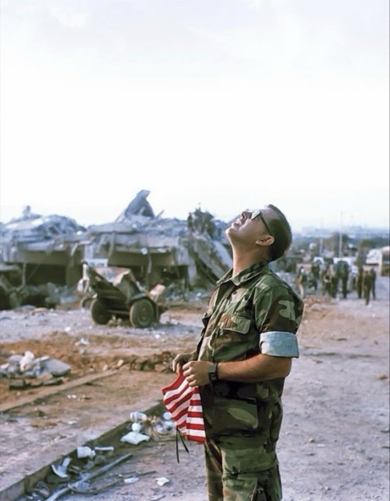 MilitaryCooI's tweet photo. A U. S. Marine from 1/8 (aka Beirut Battalion) looks up as he holds an American flag while mourning the losses of unit (241 KIA) after the H*zbollah-linked truck bombing of the U. S. Marine Barracks.

Beirut, Lebanon 1983. https://t.co/fck7ACQCYR