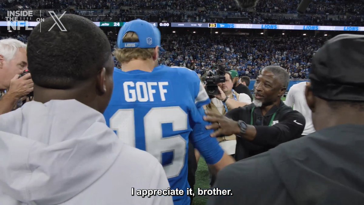 Detroit Lions quarterback Jared Goff (#16) is shown on the field with the word "GOFF" on his blue jersey, as he converses with Jets head coach Aaron Glenn, who is wearing a Jets shirt and black cap. The subtitle reads "I appreciate it, brother," capturing Goff's gratitude toward his former coach, with the scoreboard in the background showing the Jets leading 24-20.