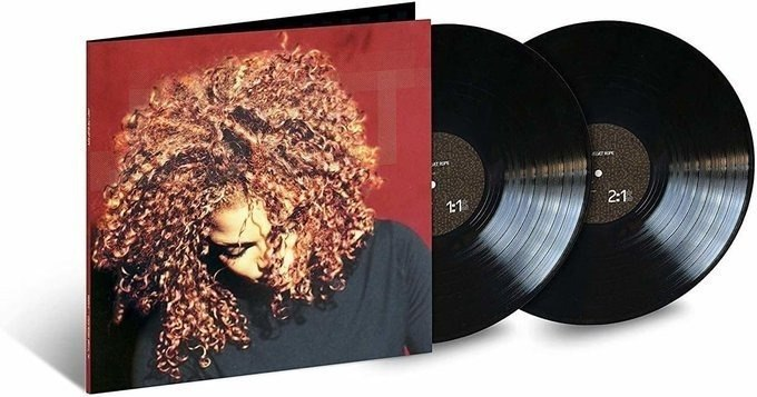 A double vinyl record set of Janet Jackson's "The Velvet Rope" album is displayed, featuring the iconic album cover with Jackson's voluminous curly hair against a red background, alongside two black vinyl discs labeled "1" and "2." The image showcases the product being sold for R$287.12 as referenced in the accompanying post.